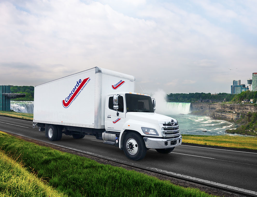 Concorde straight truck driving in front of Niagara Falls cityscape