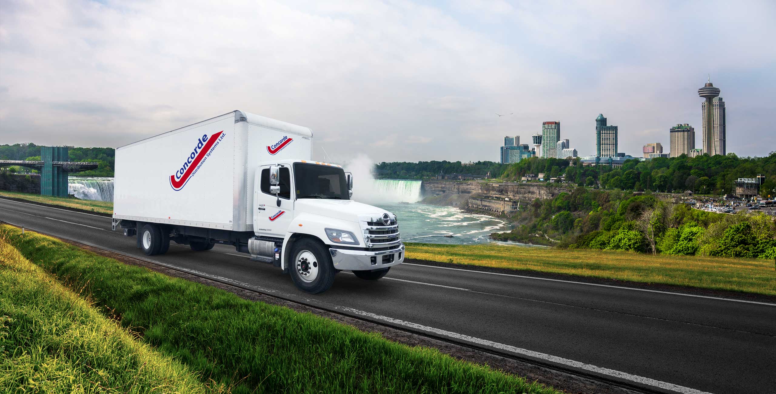 Concorde straight truck driving in front of Niagara Falls cityscape