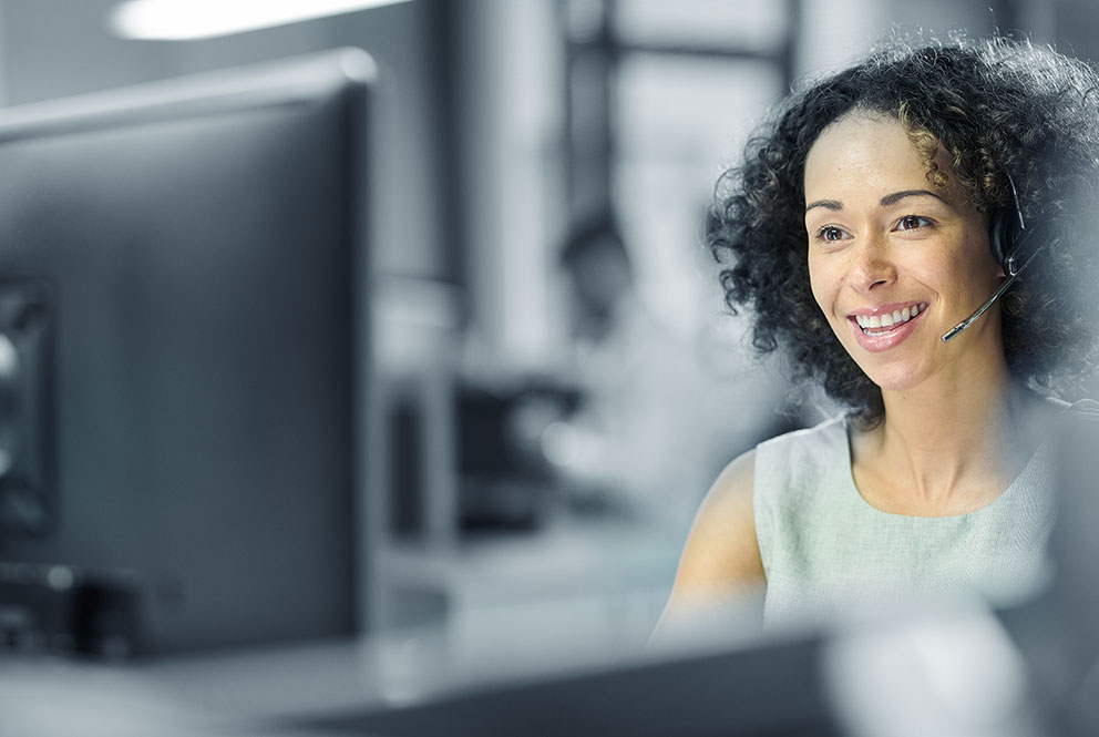 Concorde Distribution LTL professional working on computer with headset in London office