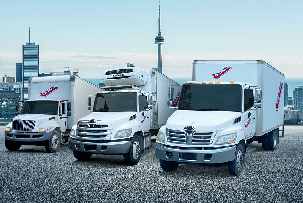Concorde city truck, reefer and straight truck in front of Toronto cityscape